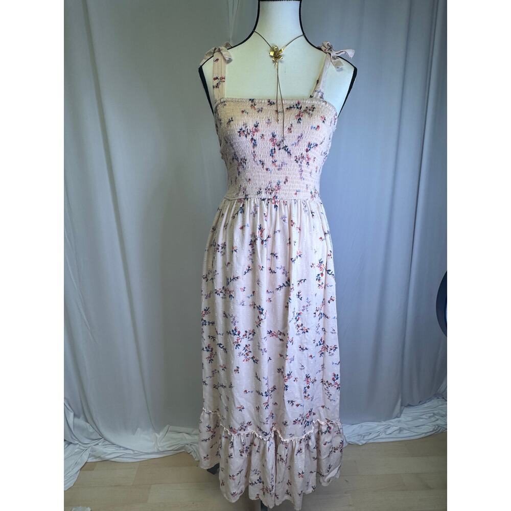 Women’s pink floral sundress with a smocked top and adjustable straps.
